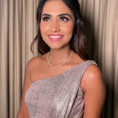 This candid, upward glance captures the beautiful radiance of the makeup. The highlighter catches the light perfectly, giving her that fresh, golden glow that looks amazing both in person and in wedding photos.