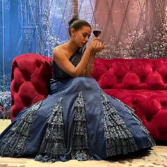 In a moment of quiet contemplation, the full splendor of this blue mermaid gown is on display, perfect for an evening of elegance and celebration.
