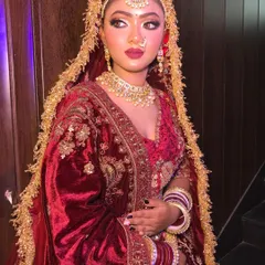 This maroon velvet lehenga features a beautiful doli motif embroidered on the skirt. It's a very traditional and royal piece, perfect for making a grand entrance.