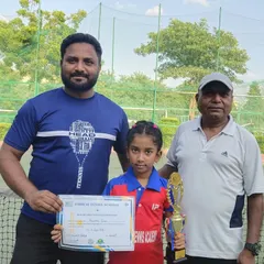 Here I am with Aashriya, the winner of the Under-8 Dunlop Open Tennis Championship. Her victory is a result of focused training and a passion for the game.
