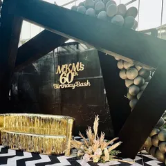 Another angle of the 60th birthday photo stage. The bold black structure, paired with the fun gold sofa and modern balloon decor, created a focal point that was both elegant and celebratory.