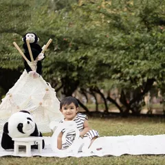 This little one is enjoying the outdoor setting, surrounded by her furry friends.