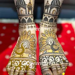 A bold and royal foot design, with large peacocks spreading their feathers under majestic palace domes.