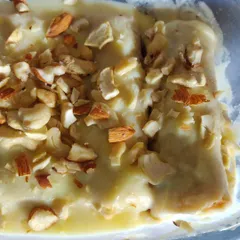 A serving of our rich and decadent Bread Malai Rolls, topped generously with chopped almonds and cashews.