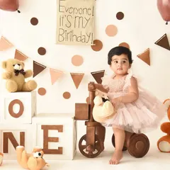 A classic teddy bear theme for a first birthday is always heartwarming. Surrounded by furry friends and festive decorations, she's ready to celebrate her special day.