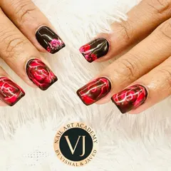 This design features a dramatic black and red marble effect, creating a look that is both luxurious and edgy. We hand-paint each swirl to achieve a unique, smoky pattern, making it a popular choice for clients who want their nails to stand out.