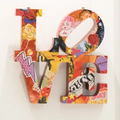 A direct frontal view of the 'Love Unleashed' installation. The piece bridges the timeless message of love with the expressive, commercial energy of pop art, creating something both nostalgic and new.