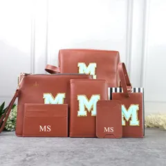 A full travel combo set in a classic tan color. All items, including the utility pouch, passport cover, and card holders, are personalized with a name or initials.