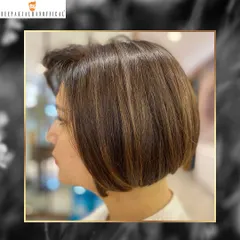 A profile view of the golden bob, showing the precision of the cut and the beautiful placement of the highlights. It's all about creating a polished, sophisticated style.
