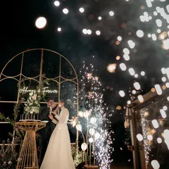 A truly magical moment. We framed the couple's reception with a custom arch and sparklers against the backdrop of a serene lake, creating an unforgettable 'Always & Forever' memory.