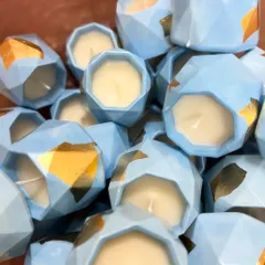 I customized these beautiful geometric jar candles in a lovely pastel blue with gold foil accents for a special baby announcement hamper. It's a wonderful way to share your happy news.