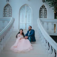A beautiful shot on a grand white staircase, reminiscent of a European palace. The bride's light pink gown adds to the romantic, fairytale atmosphere.