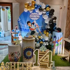 A different angle of the cricket party setup, showing the marquee letters and themed pedestals.