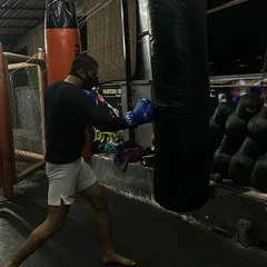 A fighter drilling his boxing form on the heavy bag. This is where you build power and endurance, one punch at a time.