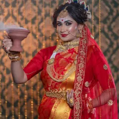 This image captures a traditional Bengali wedding ritual. The makeup is designed to be sweat-proof and long-lasting, staying perfect throughout the ceremonies.