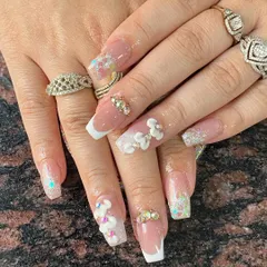 A closer look at advanced 3D floral nail art combined with a classic French manicure. This technique requires precision with acrylics, which we cover in detail.