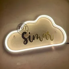 An angled view of the custom neon sign, showing how the name is mounted on a clear acrylic backing cut to the shape of the cloud.