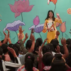 The moment a story comes to life. Here at our Library of Flowers, our volunteer captivates an audience of eager listeners. Every raised hand is a sign of curiosity sparked and a connection made, showing the immediate impact of our storytelling programs.