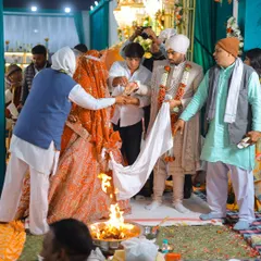 Another view of the pheras, showing the involvement of family members in the ceremony.