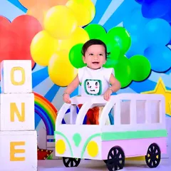 A joyful first birthday shoot with a Cocomelon theme, featuring a colorful setup and "ONE" blocks.