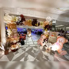 The grand entrance to a teddy bear-themed Mundan ceremony. A balloon arch in earthy tones and large, cute teddy bear cutouts welcome guests to the celebration.