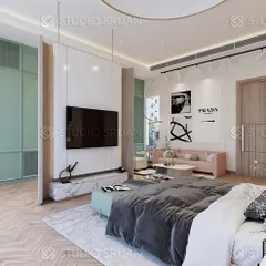 In this spacious Alameda bedroom, I used a floating TV wall as a clever divider to create a distinct dressing area behind it. The room features a soft, pastel color palette with mint green and pink, herringbone wood flooring, and a cozy sitting area.