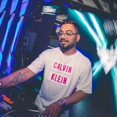 Dialed in and focused on the mix at a packed club. The right lighting and a powerful sound system are key to creating an immersive experience for any party.