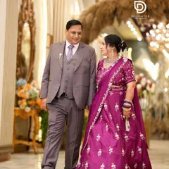 A candid shot of the couple walking hand-in-hand at their silver jubilee event. It's a beautiful moment that shows they are still on this journey together.