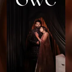A moody and romantic portrait of the couple, framed by dark curtains, creating a cinematic and intimate feel.