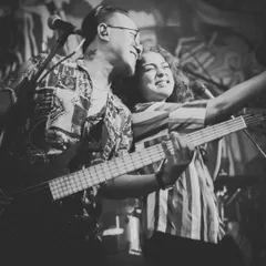A black and white portrait of us, Dhruvi and Johaan, sharing a moment on stage. This image captures the core partnership and shared passion for music that started this band.