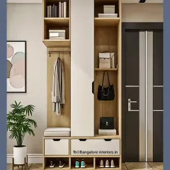 A tall entryway unit in light wood and white, offering a variety of storage options including open shelves, drawers, a coat hanging section, and shoe cubbies.