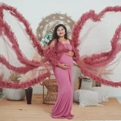 The 'gown as wings' shot is one of my most requested creative portraits. It creates a beautiful, angelic silhouette that celebrates motherhood.