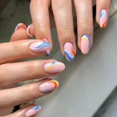 Another look at these vibrant, wavy lines. Each nail has a slightly different pattern, creating a cohesive yet unique set of abstract nail art.
