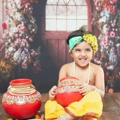 The joyful smile of a little boy dressed as Krishna for our Janmashtami mini session. The floral backdrop adds a touch of magic to the scene.