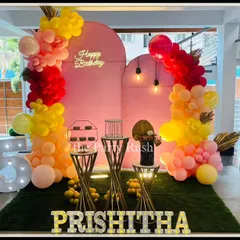 Prishitha's 25th birthday was celebrated with this modern and vibrant pink and yellow setup. The decor includes arched backdrops, a neon "Happy Birthday" sign, and stylish balloon garlands for a chic and festive look.