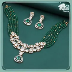A full view of our Green Grace necklace set. The arrangement of Polki diamonds and emeralds is designed for maximum impact, creating a piece that shines in every celebration. The matching earrings complete the elegant ensemble.
