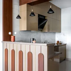 This angle shows the breakfast bar and pendant lighting, which help define the kitchen space. The design balances privacy with connectivity to the main living area.