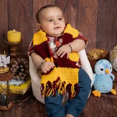 Looking up in wonder, this little wizard is taking in his magical surroundings. The warm, wooden backdrop and classic props like the globe and hourglass add to the storybook feel of the session.