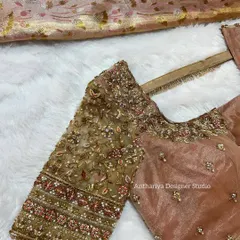 A side view of the beige sheer blouse, highlighting the intricate floral embroidery that covers the sleeves. The mix of threadwork and sequins adds a subtle sparkle.