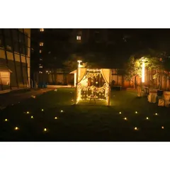 This wide shot shows how we can set up a romantic cabana in a garden or lawn, creating a private oasis complete with a candlelit path leading to the entrance.