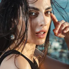 For this rooftop shoot, I created a windswept, natural look with a focus on dewy, almost wet-looking skin. The makeup is minimal to give the feeling of effortless, sun-kissed beauty.