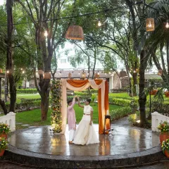 The first dance on a rustic stone stage in a beautiful garden setting. We used minimal decor to let the natural beauty of the venue shine.