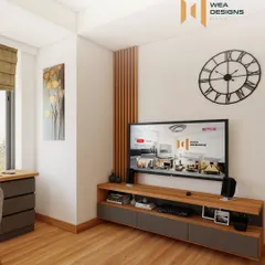 A modern TV unit in a bedroom, featuring a wooden console with grey drawers and vertical wooden slats for a touch of texture.