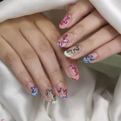 This design uses negative space with colorful, squiggly outlines on each nail. It's a fun, modern, and slightly retro look that is completely hand-painted.