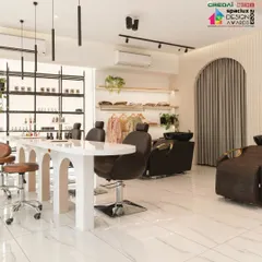 The main service area of the 'Frumos' luxury salon. The open-plan layout is defined by custom arched tables and partitions, creating a feeling of spaciousness and tranquility.