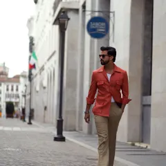 The Aperol spritz orange safari jacket, seen on the streets of Italy, blends perfectly with the European summer aesthetic.