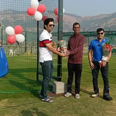 Pravin Tambe presenting a bouquet during the inauguration ceremony of our cricket academy, marking the beginning of a new chapter for youth cricket.
