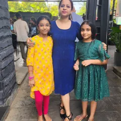 A proud teacher with her students at our Mela Music School concert. These events are a celebration of our students' success and a chance for our community to connect.