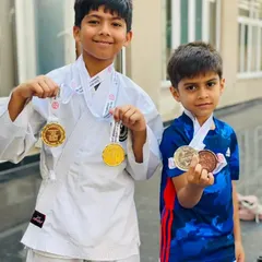 Two of my young musketeers showing off their well-earned medals after a fantastic performance at a karate championship. I am so proud of their dedication and fighting spirit.