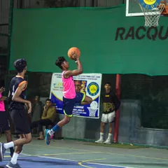 Feel the thrill of the game under the lights. This action shot from a night match on our basketball court captures the intensity and passion our players bring to every game.